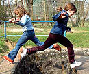 Zwei Kinder aus dem Gartenhort Darmstadt springen ber den Darmbach 